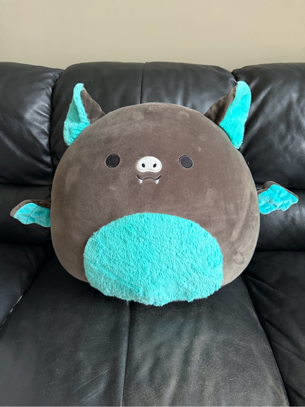 Squishmallows Brown Bat Plush with Teal Belly and Ears.